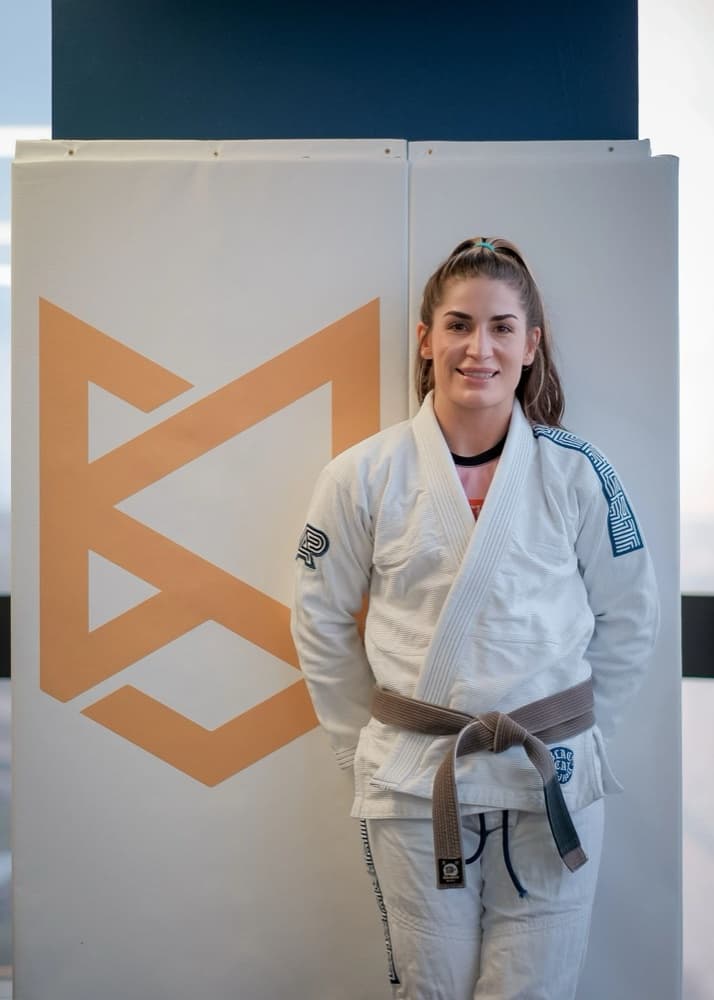 A female black belt coach at Black Cat Jiu Jitsu in Springfield, Virginia, where the women's jiu jitsu class trains.
